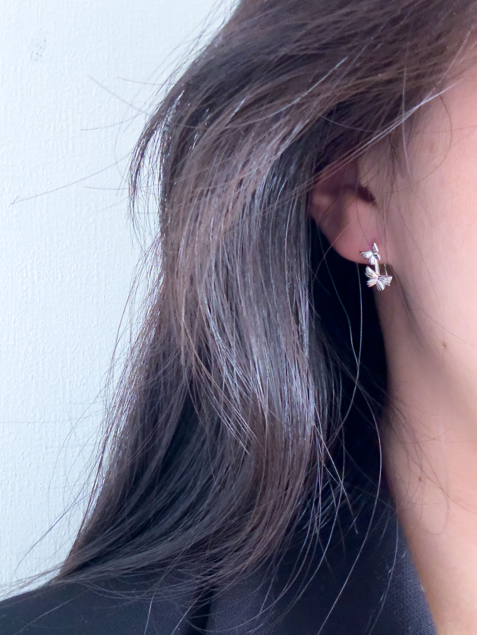 model wearing butterfly earring close-up