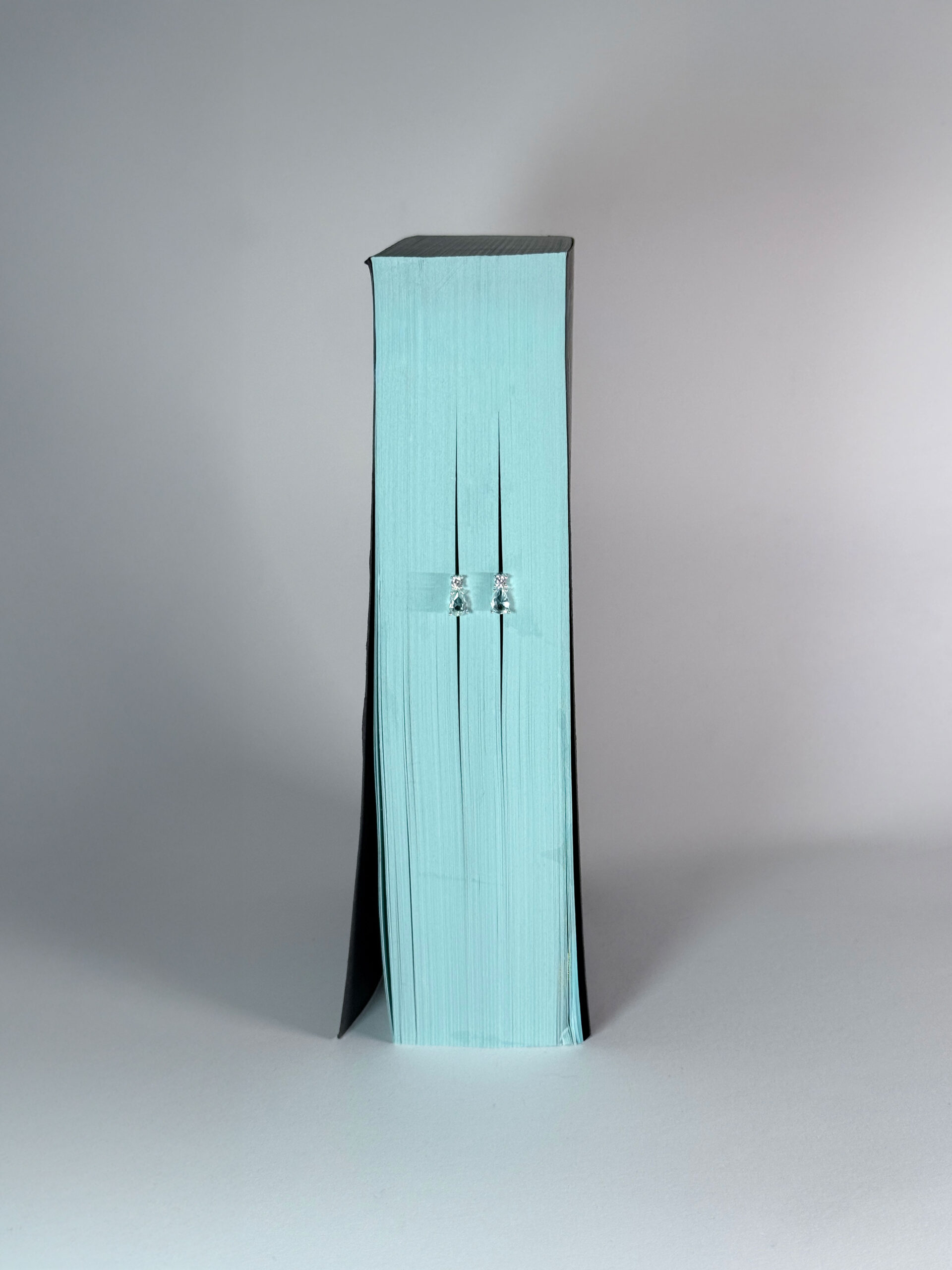 Still life - Blue Teardrop Earring on pastel background