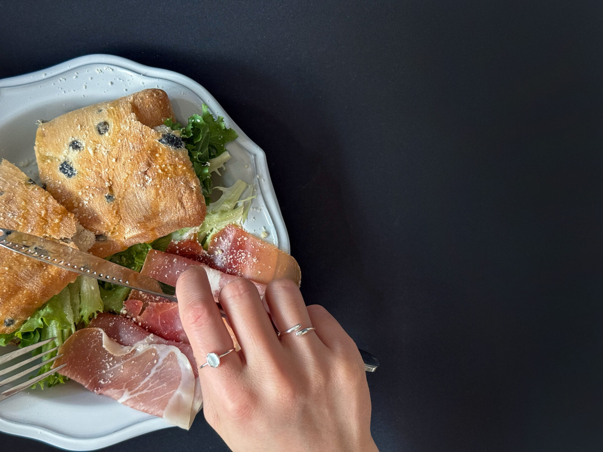 Soft Contour Ring silver hand styling on table
